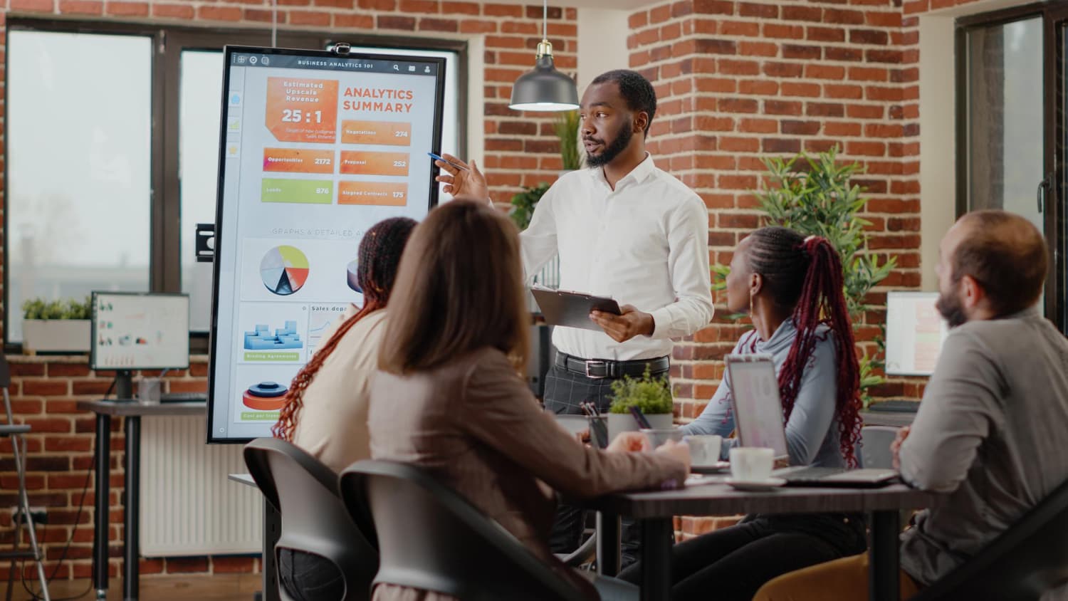 A trainer presenting business analytics to a team